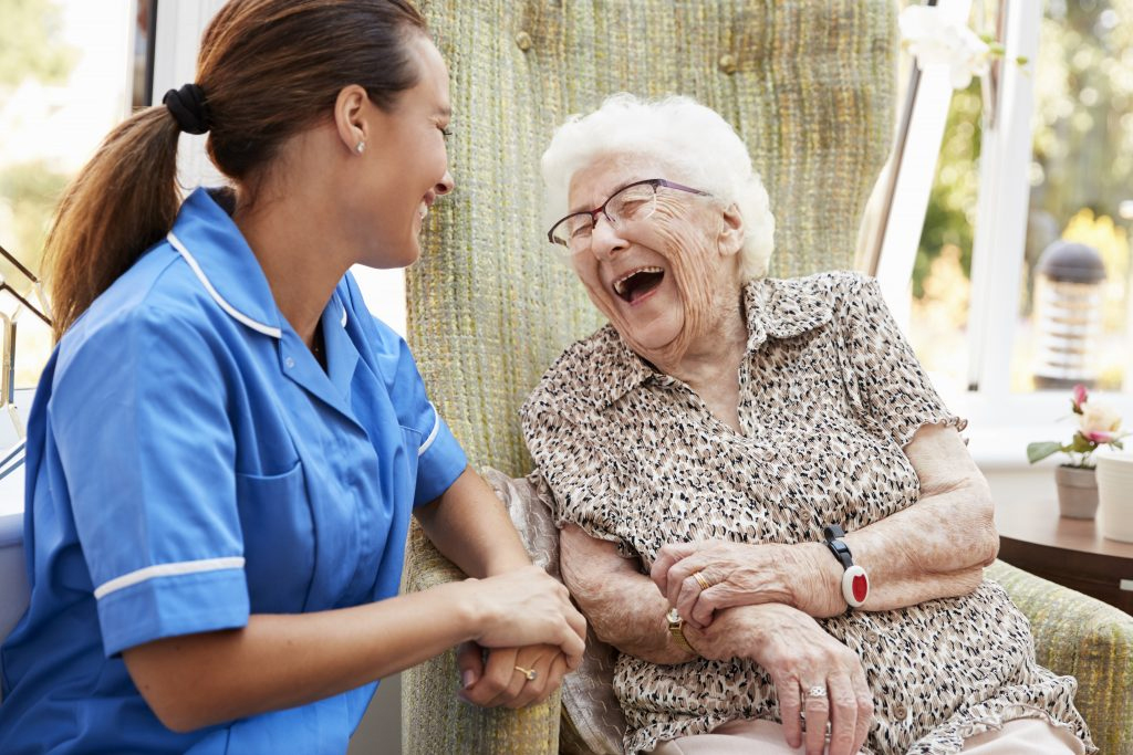 Nurse and resident laughing together